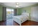Bedroom with queen-size bed and balcony access at 403 W West Ashley Ave, Folly Beach, SC 29439