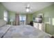 King-size bed in a light green bedroom with ocean view at 403 W West Ashley Ave, Folly Beach, SC 29439