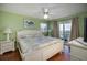 King-size bed in a light green bedroom with ocean view at 403 W West Ashley Ave, Folly Beach, SC 29439