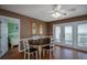 Bright dining room with hardwood floors, a round table, and access to a deck with ocean views at 403 W West Ashley Ave, Folly Beach, SC 29439
