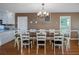 Dining room with hardwood floors and a large farmhouse style table with seating for eight at 403 W West Ashley Ave, Folly Beach, SC 29439