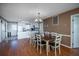 Spacious dining area with hardwood floors, a large table, and views into the kitchen at 403 W West Ashley Ave, Folly Beach, SC 29439