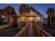Elevated beach house with boardwalk at dusk at 403 W West Ashley Ave, Folly Beach, SC 29439