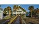 Elevated beach house with boardwalk path, two stories, and multiple balconies at 403 W West Ashley Ave, Folly Beach, SC 29439