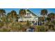 Beach house with boardwalk, palm trees, and two stories at 403 W West Ashley Ave, Folly Beach, SC 29439