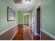 Light green hallway with wood floors and neutral decor at 403 W West Ashley Ave, Folly Beach, SC 29439