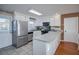Clean kitchen featuring white cabinets, stainless steel appliances, and tile floors at 403 W West Ashley Ave, Folly Beach, SC 29439