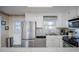 Bright kitchen with stainless steel appliances and white cabinets, near dining area at 403 W West Ashley Ave, Folly Beach, SC 29439