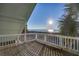 Deck with white railing offering stunning ocean views at sunrise at 403 W West Ashley Ave, Folly Beach, SC 29439