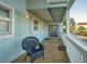 Upper-level porch with wicker chair and sliding glass door access at 403 W West Ashley Ave, Folly Beach, SC 29439