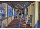 Peaceful porch with rocking chairs, wooden floors and white railings at 403 W West Ashley Ave, Folly Beach, SC 29439