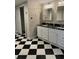 Modern bathroom with a double vanity, black and white checkered floor, and a walk-in shower at 4765 S Constellation Dr, North Charleston, SC 29418