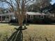 Brick ranch house with a tree in front and a well manicured lawn at 4765 S Constellation Dr, North Charleston, SC 29418
