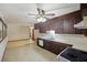 Bright kitchen features dark wood cabinets, tile floors, and a view into the dining area at 4765 S Constellation Dr, North Charleston, SC 29418