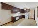 Kitchen with dark wood cabinets, tile floor, and white appliances at 4765 S Constellation Dr, North Charleston, SC 29418