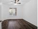 Bright bedroom featuring dark wood-look flooring and ceiling fan at 500 Bucksley Ln # 205, Charleston, SC 29492