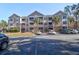 Two-story apartment building with ample parking and lush landscaping at 500 Bucksley Ln # 205, Charleston, SC 29492