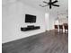 Spacious living room with dark hardwood floors and a mounted TV at 500 Bucksley Ln # 205, Charleston, SC 29492