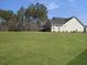 Large backyard with grassy area and wooded backdrop at 502 Chloe Elizabeth Ct, Huger, SC 29450