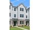 Three-story townhome with white siding, gray roof, and brick accents at 5112 Double Eagle, Summerville, SC 29485