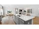 Large kitchen island with white quartz countertops and seating for three at 563 Richfield Way, Summerville, SC 29486