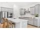 Modern kitchen with gray cabinets, white quartz countertops, and stainless steel appliances at 563 Richfield Way, Summerville, SC 29486