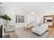 Open living room with white sectional sofa, large windows, and a stylish chandelier at 563 Richfield Way, Summerville, SC 29486