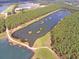 Aerial view of tranquil lake with lush green shoreline and trees at 566 Richfield Way, Summerville, SC 29486