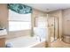 Elegant bathroom with a soaking tub and a walk-in shower at 566 Richfield Way, Summerville, SC 29486