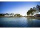 Peaceful lakefront view with mature trees and a home in the background at 566 Richfield Way, Summerville, SC 29486