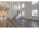 Two-story living room with hardwood floors and a staircase to the second floor at 566 Richfield Way, Summerville, SC 29486