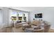 Bright living room features a comfy sofa and large windows at 568 Richfield Way, Summerville, SC 29486