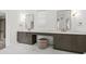Double vanity bathroom with marble countertops and gold fixtures at 66 Warren St # Entire Property, Charleston, SC 29403