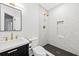 Modern bathroom with a walk-in shower, marble tile, and gold fixtures at 66 Warren St # Entire Property, Charleston, SC 29403