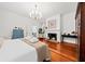 Large bedroom with hardwood floors, fireplace, and ensuite bathroom at 66 Warren St # Entire Property, Charleston, SC 29403