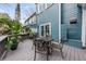 Private deck with wrought iron furniture and lush greenery at 66 Warren St # Entire Property, Charleston, SC 29403