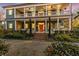 Two-story home with wraparound porch and manicured landscaping at 66 Warren St # Entire Property, Charleston, SC 29403
