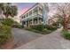 Stunning two-story home with a gravel driveway and lush landscaping at 66 Warren St # Entire Property, Charleston, SC 29403