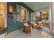Relaxing front porch with wicker chairs and a wooden coffee table at 66 Warren St # Entire Property, Charleston, SC 29403