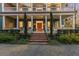 Two-story home with inviting front porch and brick steps at 66 Warren St # Entire Property, Charleston, SC 29403