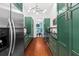 Butler's pantry with green cabinets, quartz countertops, and wine cooler at 66 Warren St # Entire Property, Charleston, SC 29403