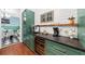 Coffee bar with green cabinets and a built-in wine refrigerator at 66 Warren St # Entire Property, Charleston, SC 29403