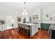 Spacious kitchen with marble island, green cabinets, and hardwood floors at 66 Warren St # Entire Property, Charleston, SC 29403