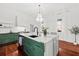 Bright kitchen with a marble island, green cabinetry, and hardwood floors at 66 Warren St # Entire Property, Charleston, SC 29403