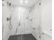 Spa-like shower with marble tile and glass enclosure at 66 Warren St # Entire Property, Charleston, SC 29403