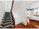 Elegant staircase with dark wood railings and patterned carpeting leading to the upper level at 66 Warren St # Entire Property, Charleston, SC 29403