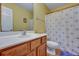 Bathroom with wood vanity, shower/tub combo, and white toilet at 7963 Shadow Oak Dr, North Charleston, SC 29406
