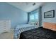 Blue bedroom with two beds, dresser, and ceiling fan at 7963 Shadow Oak Dr, North Charleston, SC 29406