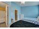 Blue bedroom with two beds, ceiling fan, and access to bathroom at 7963 Shadow Oak Dr, North Charleston, SC 29406
