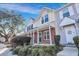 Front view of townhouses with landscaping and brick accents at 7963 Shadow Oak Dr, North Charleston, SC 29406